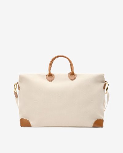 Stor reiseveske i off white bomullscanvas med detaljer i lysebrunt skinn