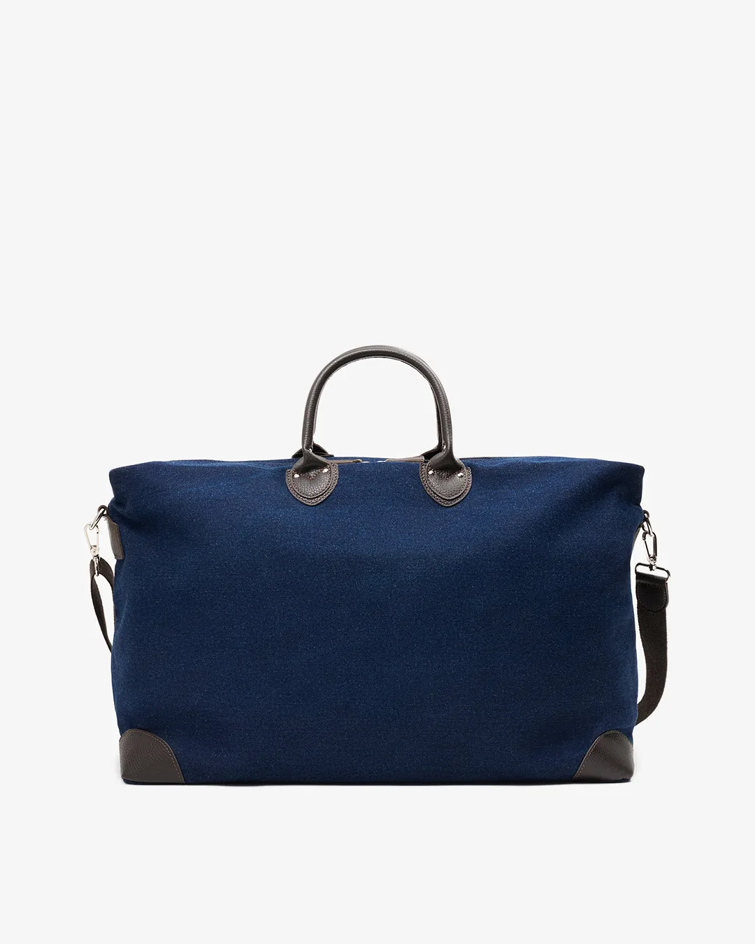 Stor reiseveske i mørkeblå denim med detaljer i brunt skinn